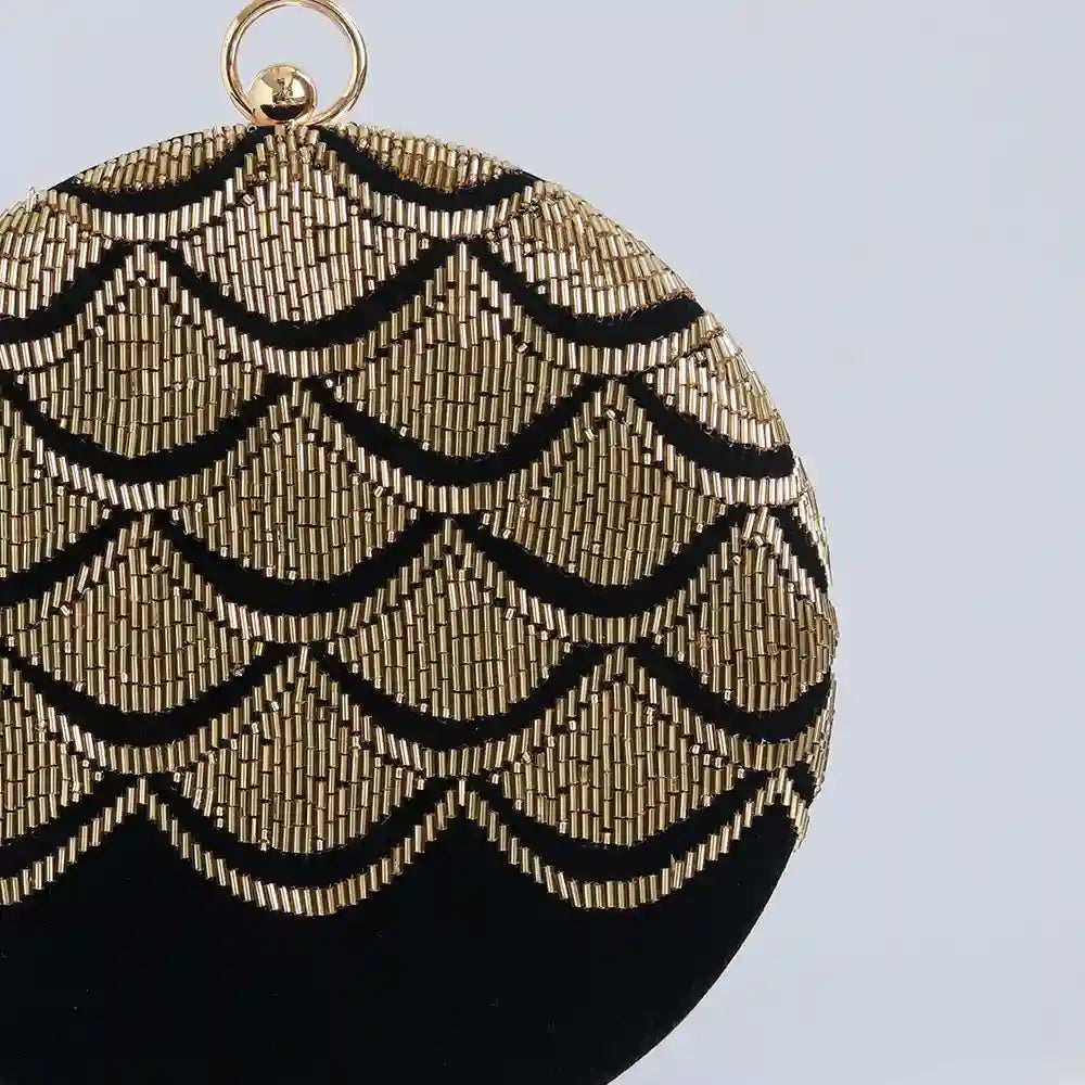 Hand-embroidered Rajwada clutch by The Tan Clan featuring intricate traditional design and vibrant colors.