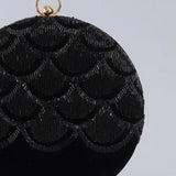 Elegant Rajwada hand-embroidered clutch in vibrant colors with intricate traditional patterns, crafted by The Tan Clan.