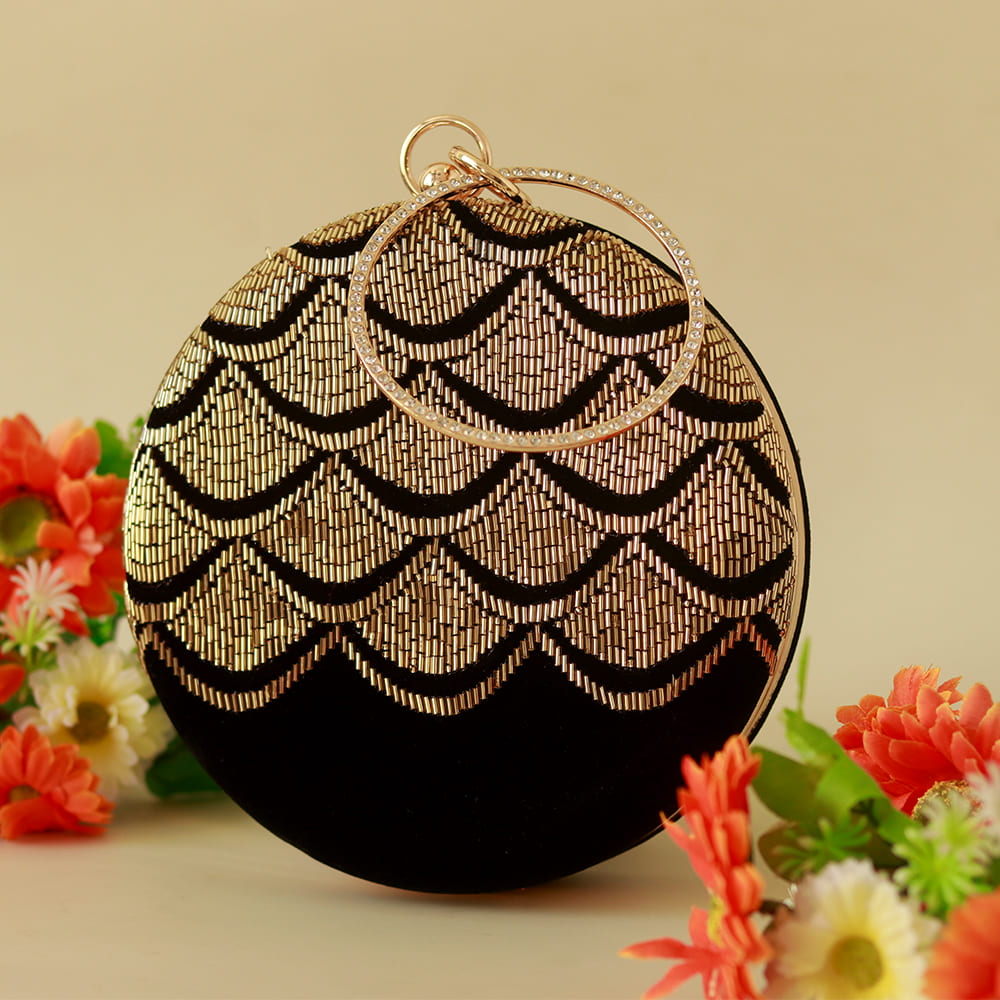 Black and gold Rajwada hand-embroidered clutch bag by The Tan Clan featuring intricate traditional embroidery.