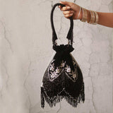 Rangreza combo featuring Keisha black tassel potli and Sharda silver potli bag with intricate designs and decorative tassels.
