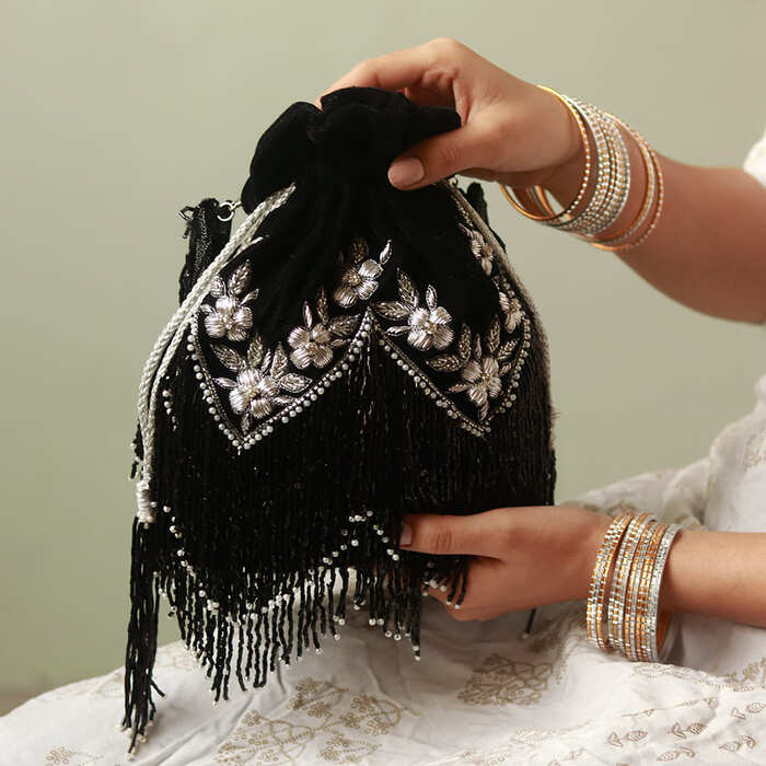 Rangreza Combo featuring Keisha black tassel potli and Sharda silver potli bag with intricate designs, perfect for festive occasions.
