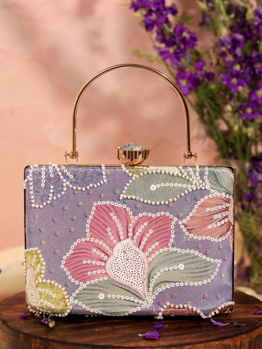 Multicolor Riveria Casket Clutch by The Tan Clan with vibrant patterns and a sleek rectangular design.