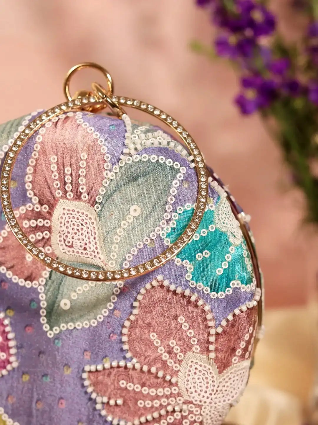 Riveria multicolor round clutch bag by The Tan Clan featuring vibrant, multicolored patterns and a compact, circular design.