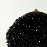 Black Rosa Batua bag by The Tan Clan with a detachable handle, showcasing its sleek design and versatile carry options.