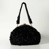 Black Rosa Batua bag with detachable handle from The Tan Clan, showing the stylish, versatile design and textured material.