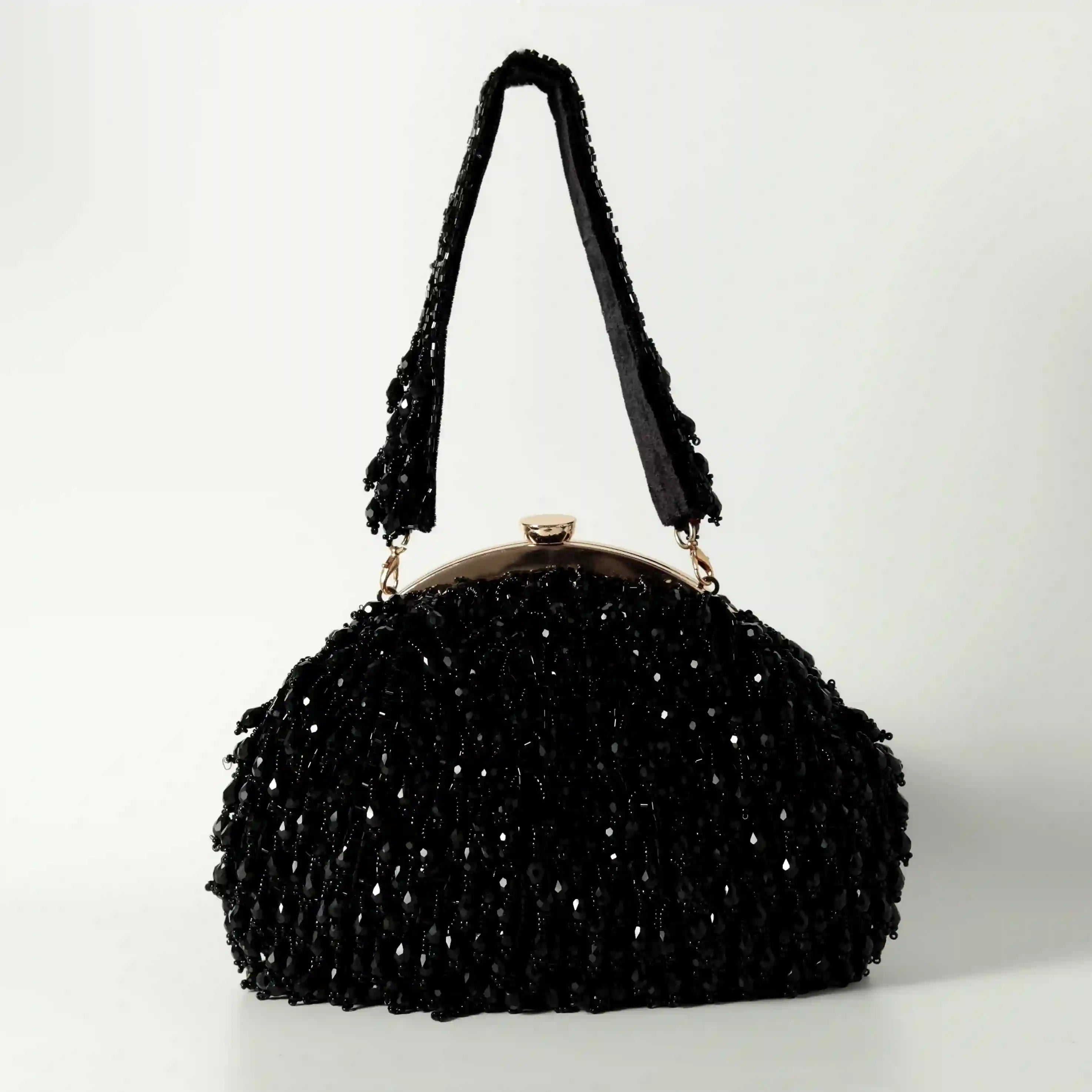 Black Rosa Batua bag with detachable handle from The Tan Clan, featuring a sleek design and versatile carrying options.