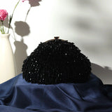 Black Rosa Batua bag by The Tan Clan with a detachable handle, featuring a sleek, stylish design for versatile wear.