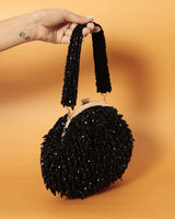 Black Rosa Batua bag with detachable handle from The Tan Clan, featuring a sleek design and versatile carrying options.