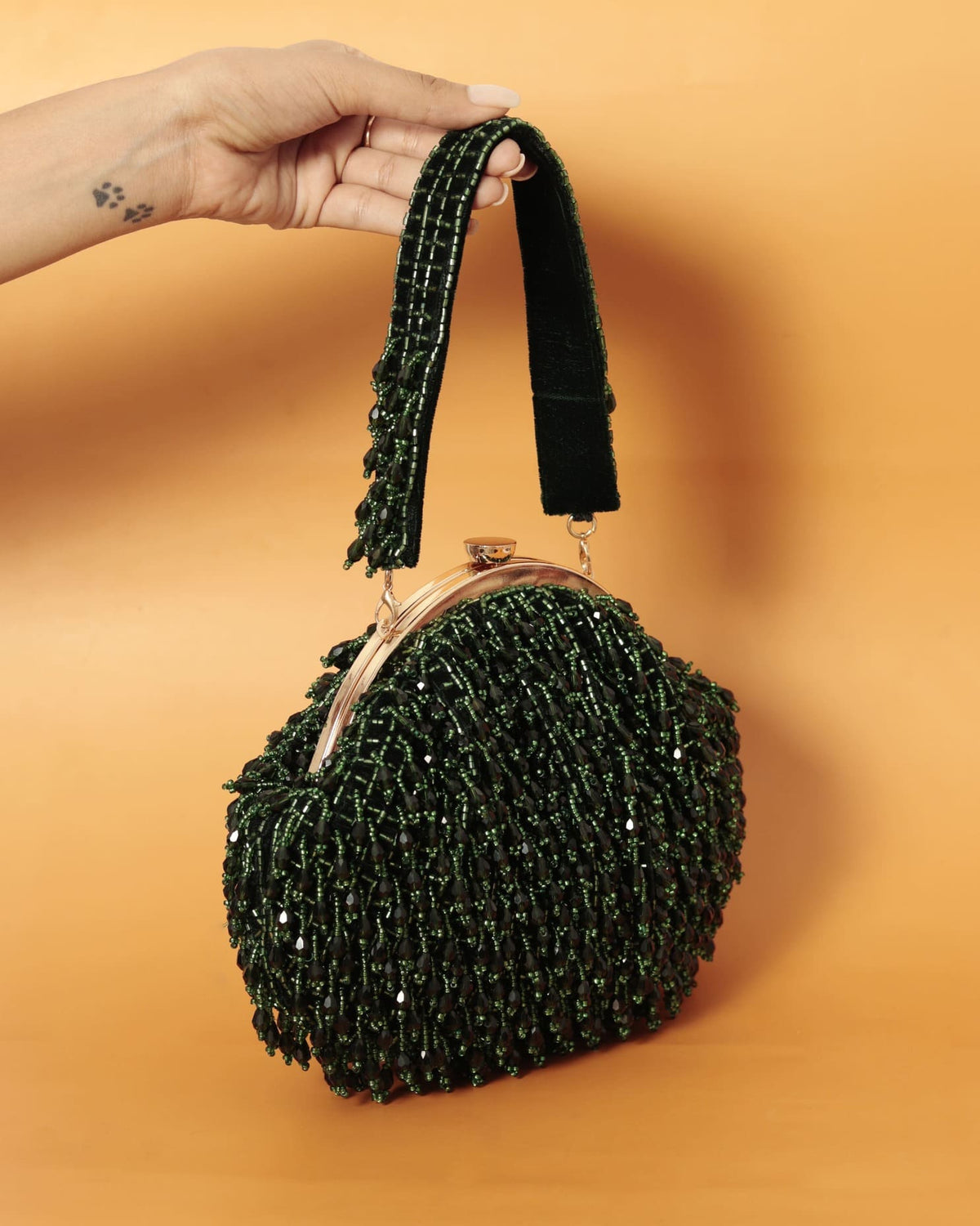 Emerald Rosa Batua Bag by The Tan Clan with a detachable handle, showcasing a stylish and versatile accessory.