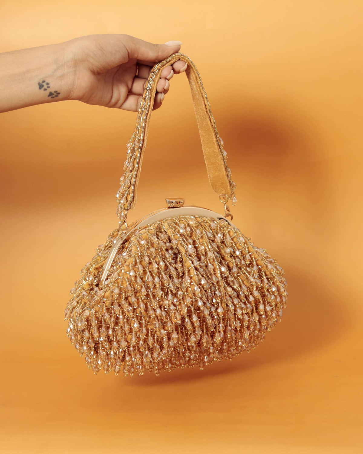 Golden Rosa Batua bag with detachable handle by The Tan Clan, showing its elegant design and versatile carrying options.