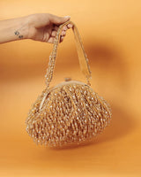 Golden Rosa Batua bag with detachable handle by The Tan Clan, showing its elegant design and versatile carrying options.