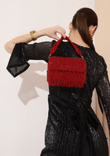 Beaded pink flap-over clutch bag by The Tan Clan with intricate beadwork and a stylish design for elegant occasions.