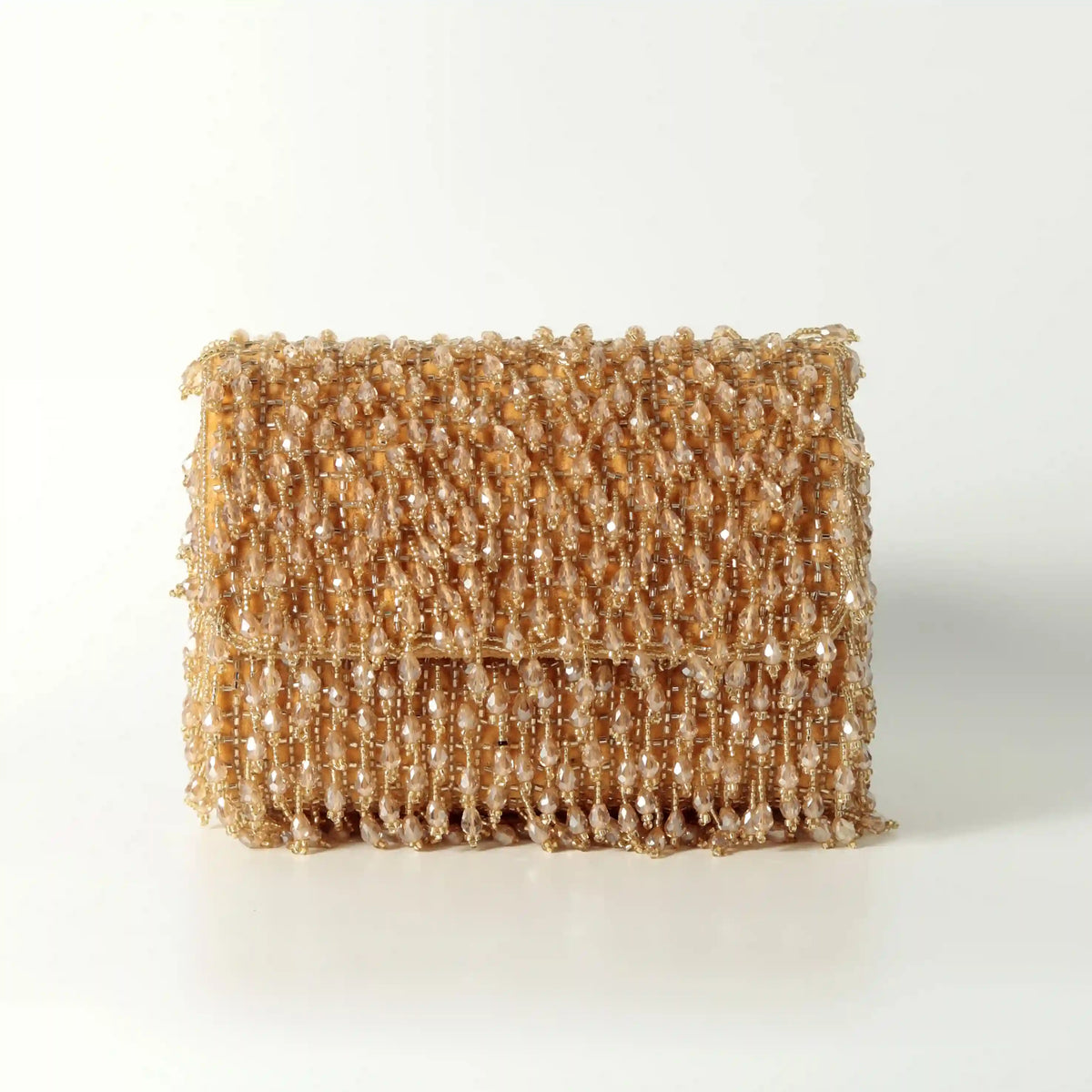 Pink beaded flap-over clutch bag by The Tan Clan featuring intricate beadwork and a sleek design.