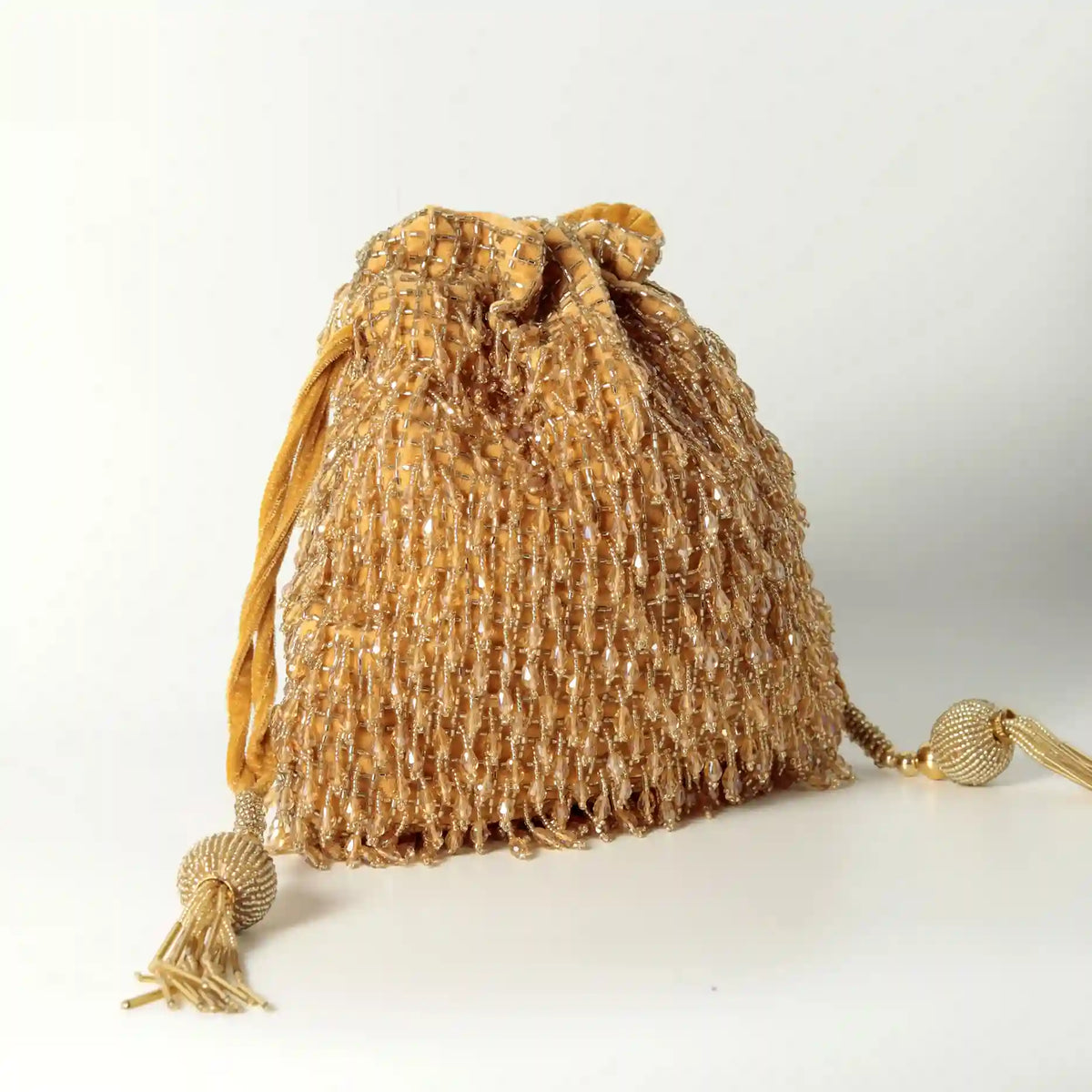 Pink Rosa Potli Bag with handle from The Tan Clan, featuring traditional embroidery and a drawstring closure.