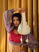 Ruhi Potli bag with handle by The Tan Clan featuring traditional design and decorative details.