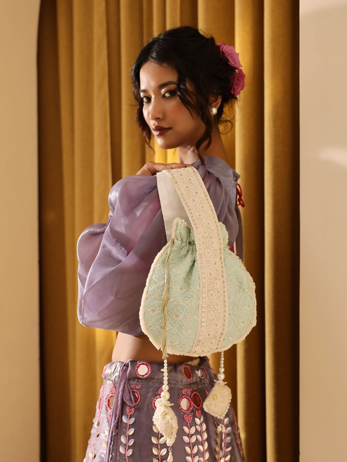 Ruhi Potli bag with handle by The Tan Clan, featuring traditional embroidery and compact design for elegant carrying.