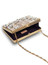 Elegant brass clutch with intricate embellishments by The Tan Clan, featuring detailed craftsmanship and stylish design.