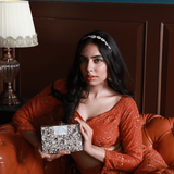 Saba embellished brass clutch by The Tan Clan featuring intricate detailing and a sleek, compact design for elegant occasions.