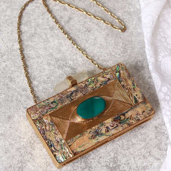 Golden embellished brass clutch with intricate design, featuring the Sahiba style from The Tan Clan.