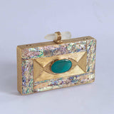 Golden embellished brass clutch bag with intricate details, designed by The Tan Clan for elegant occasions