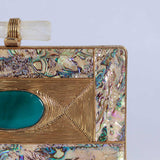Golden embellished brass clutch bag by The Tan Clan with intricate detailing and traditional design.
