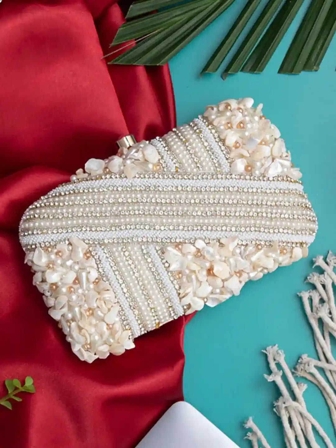 Saliha hand-embroidered clutch bag by The Tan Clan featuring intricate embroidery and a sleek, elegant design.