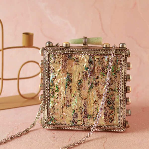 Salma Mother of Pearl clutch bag by The Tan Clan featuring a sleek design and elegant pearl detailing.