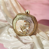 Sana Embellished Mother of Pearl Clutch by The Tan Clan featuring intricate pearl embellishments and elegant design.