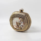 Sana Embellished Mother of Pearl Clutch by The Tan Clan, featuring intricate embellishments and a sleek design.