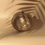 Elegant Sana embellished mother of pearl clutch by The Tan Clan, featuring intricate design and polished pearl accents.