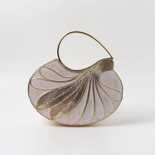 Saniya embellished mother of pearl clutch by The Tan Clan featuring intricate beadwork and a sleek rectangular design.