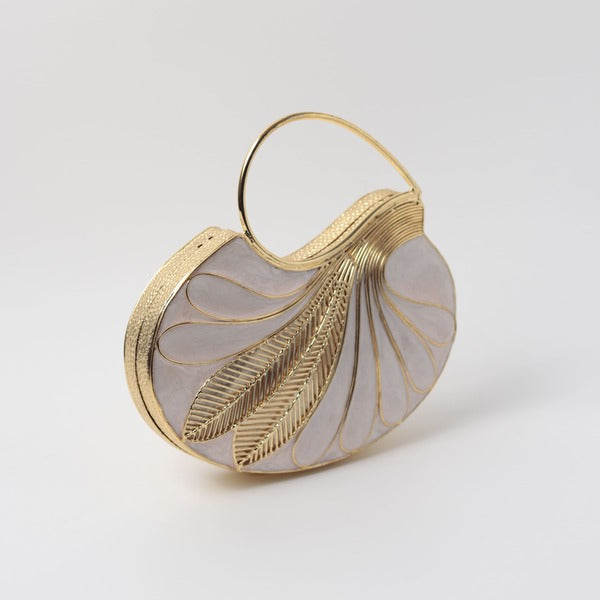 Elegant Saniya embellished mother of pearl clutch by The Tan Clan with intricate detailing and a sleek design.