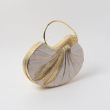Elegant Saniya embellished mother of pearl clutch by The Tan Clan with intricate detailing and a sleek design.