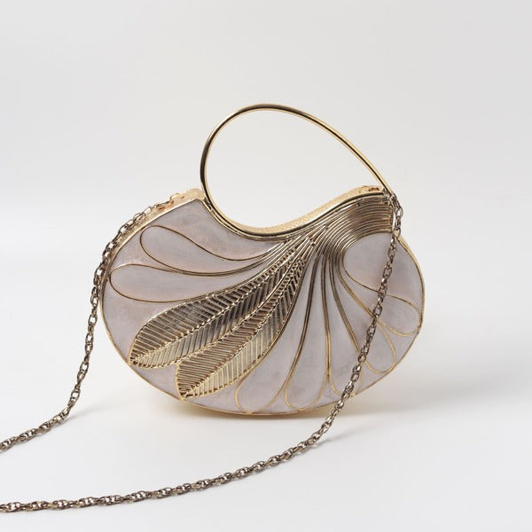 Saniya embellished mother of pearl clutch by The Tan Clan featuring intricate beadwork and a sleek rectangular design.