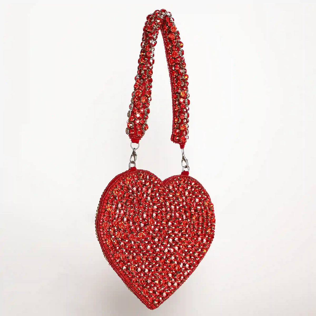 Scarlett Mini Heart Bag by The Tan Clan featuring a small red heart-shaped leather purse with a chain strap.