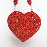 Scarlett Mini Heart Bag by The Tan Clan showing a small pink heart-shaped handbag with a top handle and gold accents.