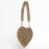 Scarlett Mini Heart Bag by The Tan Clan featuring a compact pink leather design with a gold chain strap.