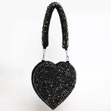 Scarlett Mini Heart Bag by The Tan Clan featuring a small pink heart-shaped leather purse with a chain strap and gold accents.