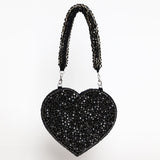 Scarlett Mini Heart Bag by The Tan Clan showing a small pink leather handbag with a heart shape and adjustable strap.