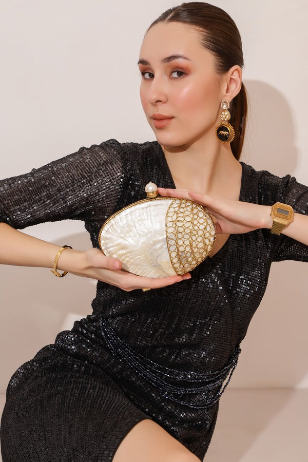 Seep Mother of Pearl Clutch by The Tan Clan featuring a shimmering pearl exterior and elegant design for formal occasions.