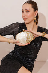 Seep Mother of Pearl Clutch by The Tan Clan featuring a shimmering pearl exterior and elegant design for formal occasions.