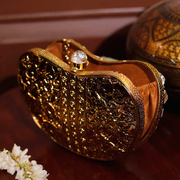 Golden Seher embellished brass clutch bag with intricate designs from The Tan Clan, featuring a compact and elegant style.