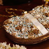 Golden Seher embellished brass clutch bag by The Tan Clan with intricate detailing and elegant design.
