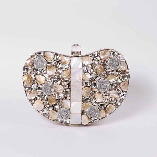 Silver brass clutch bag with intricate embellishments and elegant design, crafted by The Tan Clan.