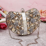 Silver brass clutch bag with intricate embellishments, featuring elegant design and a metallic finish, by The Tan Clan.