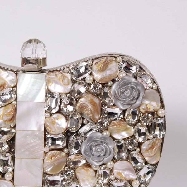 Silver Seher embellished brass clutch bag by The Tan Clan with intricate detailing and a sleek, elegant design.
