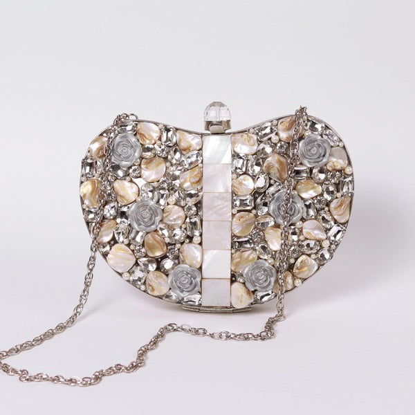 Silver Seher embellished brass clutch bag by The Tan Clan with intricate detailing and elegant design.