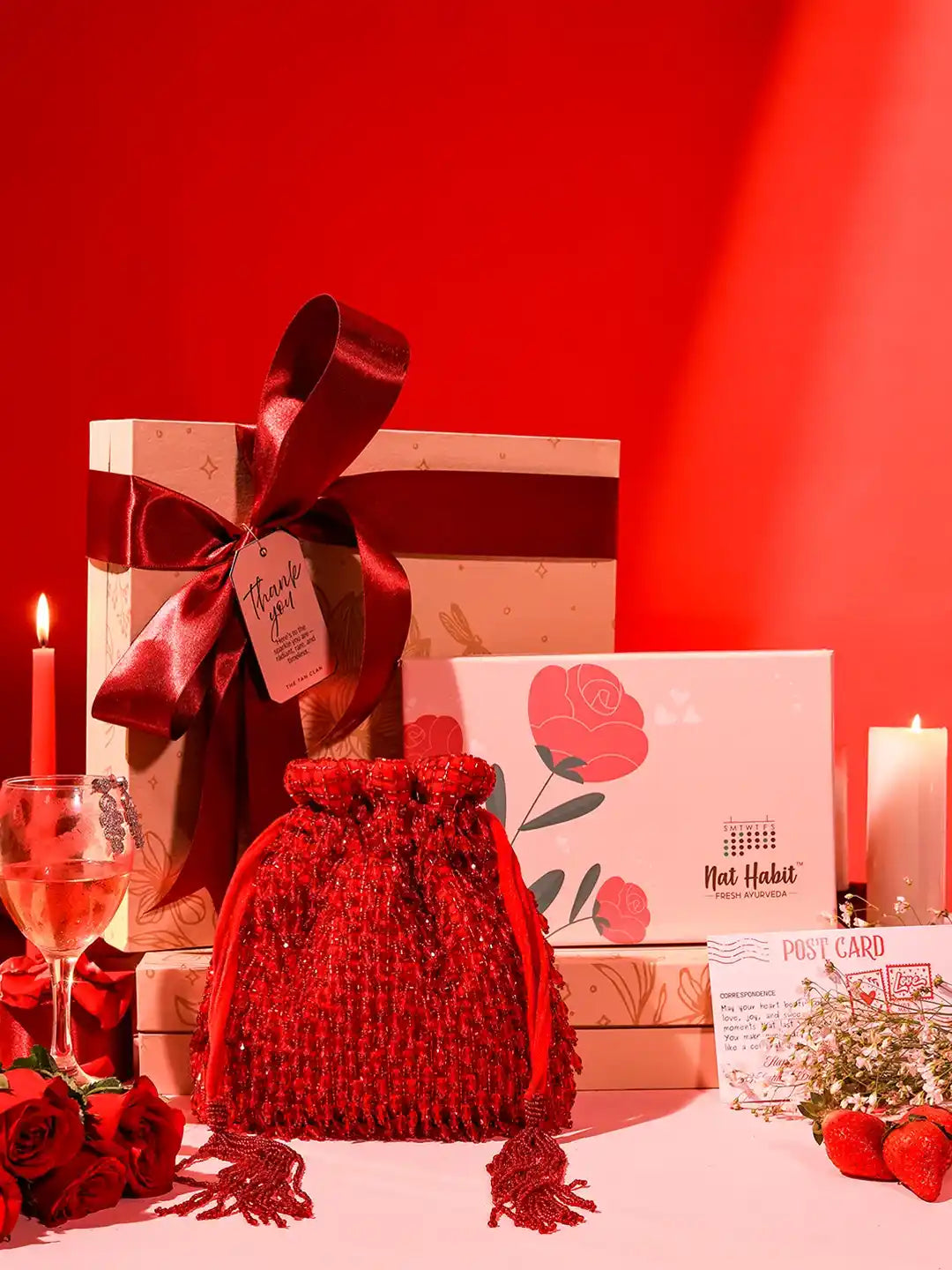 Self-care gift set by THE TAN CLAN featuring a Rosa potli bag and Nathabit, includes six skincare or wellness products.