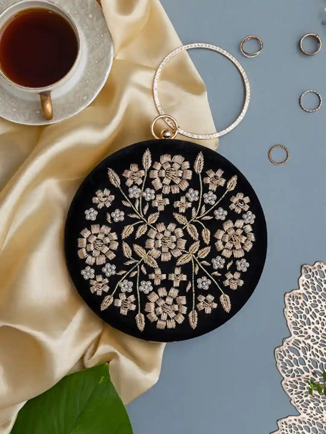 Black embroidered clutch bag with intricate hand embroidery, featuring a sleek design from The Tan Clan's Shalimar collection.