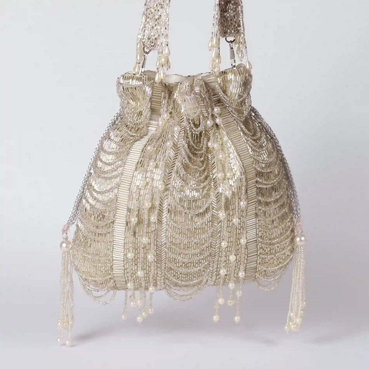 Sharda Potli Bag with Handle by The Tan Clan, showcasing intricate embroidery and traditional design in a versatile accessory.